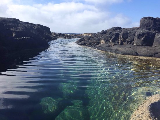 natural pools of Los Charcones with black rocks